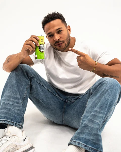 Cole sitting on the floor, pointing at a can of HfreeO